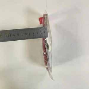 Measuring small red faux leather Christmas stocking showing 12cm length with ruler