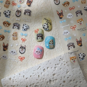 Detail view of 5D dog themed embossed nail stickers with cartoon husky and poodle designs