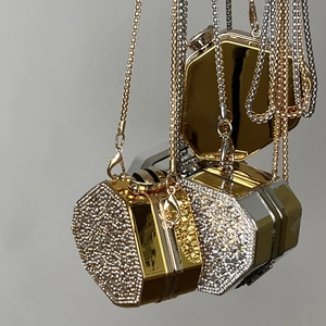 Close-up of luxury mini rhinestone hexagon evening bags in gold and silver with chain