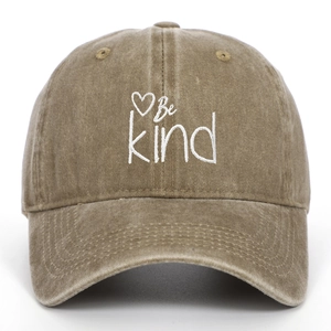 Close-up of Be Kind embroidery and heart pattern on washed cotton baseball cap