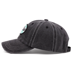 Dark grey washed cotton baseball cap with white contrast stitching and circular patch