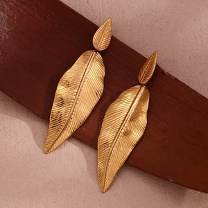 Exaggerated 18K gold plated stainless steel double leaf earrings on a wooden background