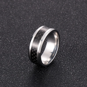 Macro view of 8mm stainless steel ring with black carbon fiber inlay and roman numerals