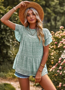 Detail of layered ruffle butterfly sleeves on green floral print summer t-shirt