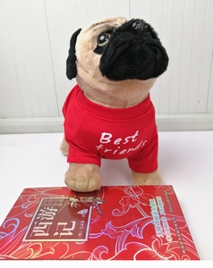 Close-up of a plush pug toy wearing a red Best Friends t-shirt on a white background