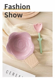 Detail of pink tulip ceramic spoon with rose flower bowl on a wooden tabletop