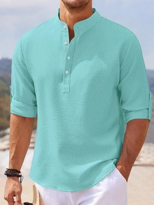 Detailed close-up of teal waffle knit fabric and four-button placket on men's polo shirt