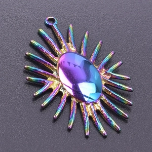 Detail of 18k gold plated sunburst pendant with rainbow finish and oval gemstone