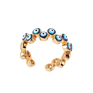 Adjustable gold plated evil eye ring with blue and white enamel droplets on white background
