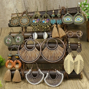 Bohemian earring set detail featuring turquoise tassels and vintage bronze hollow patterns