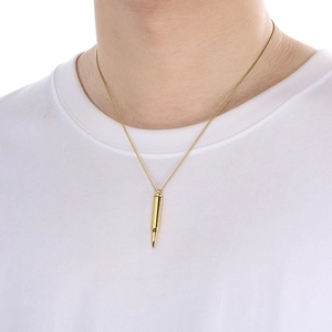 Polished gold bullet pendant necklace for men shown on a model wearing white t-shirt
