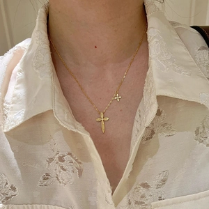 24K gold plated necklace with cross and flower charms on model neck for daily look