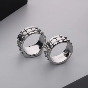 Detail of vintage silver square rings with textured industrial grip and polished inner band