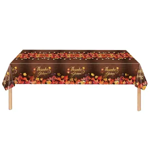 Close-up of Thanksgiving tablecloth featuring wood grain, maple leaves and acorns