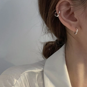 Detail view of s925 silver Mobius ear cuff and stud earring set worn by a model