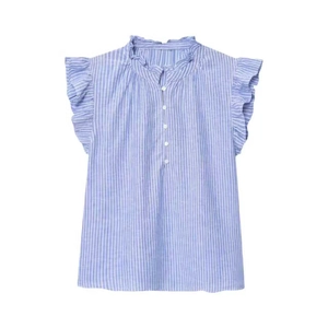 Detailed view of ruffled collar and sleeveless armholes on light blue striped linen shirt