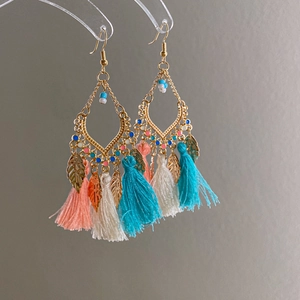 Detail view of Bohemian long tassel earrings with colorful beads and golden leaf charms