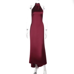 Detail of burgundy backless halter satin dress showing the glossy fabric and drape