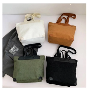 Flat lay view of corduroy tote bags in cream, brown, olive green, and black colors