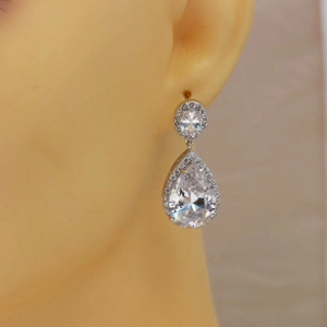 Elegant silver-tone pear-cut AAA zircon drop earrings worn by a model for a classic look