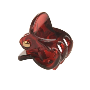 Deep red translucent plastic hair claw clip with golden metal spring on white background
