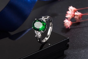 Close-up of S925 sterling silver hallmark on emerald ring with zircon accents