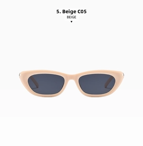 Detail of beige cat-eye sunglasses featuring lightweight frame and dark grey lenses