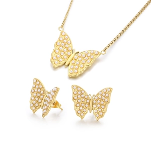 Elegant gold titanium steel jewelry set featuring butterfly motifs with white pearls