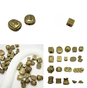 Macro shot of antique bronze brass spacer beads with engraved Chinese zen characters