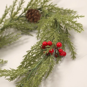 Artificial Christmas garland with green cypress leaves, red berries, and natural pinecone