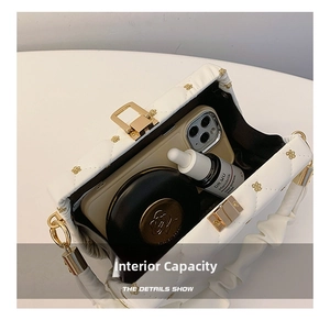 Interior view of white quilted evening bag holding a smartphone and cosmetics