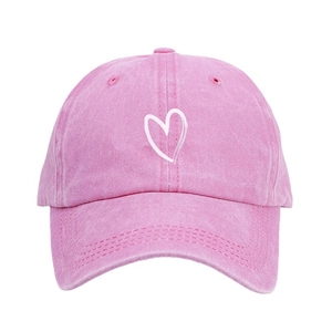 Pink washed cotton baseball cap featuring a white heart embroidery on front