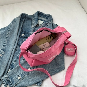Pink nylon crossbody bag showing large capacity storage with umbrella and cosmetics