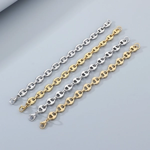 Detail of pig nose chain link bracelets in gold and silver finish with lobster clasps