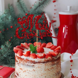 Sparkly red Merry Christmas cake topper with tree detail on strawberry cake