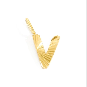 Detailed close-up of golden letter V pendant with refined sunburst texture finish