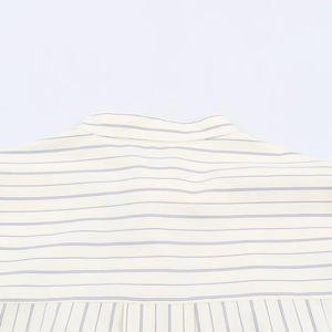 Detailed close-up of striped shirt collar and back stitching on smooth cotton fabric