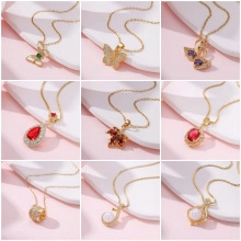 Grid layout showing various gold necklaces with butterfly, swan, and geometric pendants