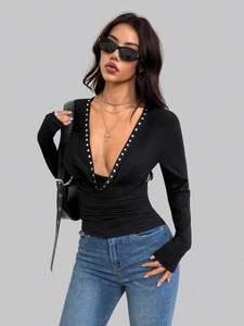 Slim fit black long sleeve top featuring V-neckline with silver stud embellishments