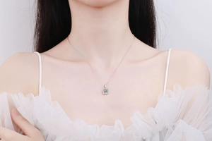 Elegant silver square pendant necklace with moissanite stones shown on a model neck