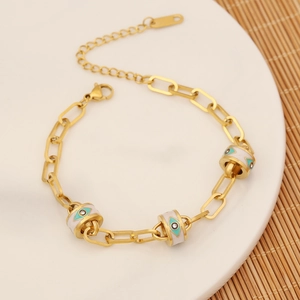 Gold paperclip chain bracelet with three blue enamel evil eye beads and adjustable clasp