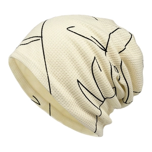 Cream knitted beanie with black abstract print, slouchy style for women's winter fashion