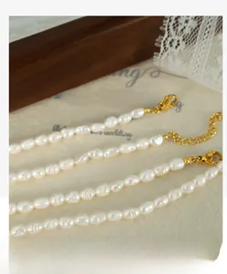 Close-up of baroque freshwater pearl necklace with gold lobster clasp and extension chain
