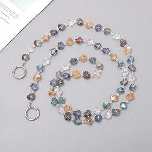 Detailed view of colorful iridescent multifaceted crystal beads with silver spring clasps