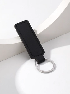 Detail shot of a premium black PU leather strap keychain with a polished silver metal ring