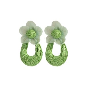 Detailed view of light green mesh petals and woven raffia center of the floral earring