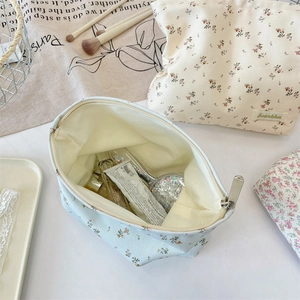 Detail of floral canvas makeup bags with metal zippers and spacious interior storage