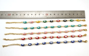 Detailed view of evil eye bracelets in various colors with measurement ruler