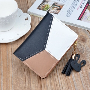 Short tri-color wallet with zipper and cute bunny tassel pendant on wooden background