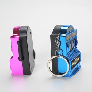 Detailed view of mini lucky slot machine keychains in pink and electroplated blue